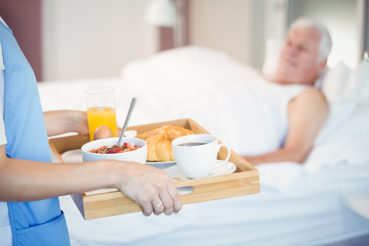 caregiver-nurse-with-breakfast-in-tray